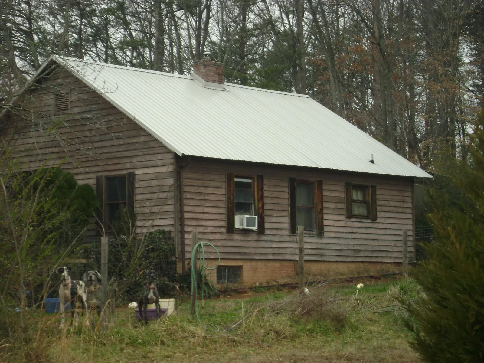 White metal roof on an old wood sided farmhouse, from a Metal Roof Installation job in Parish
